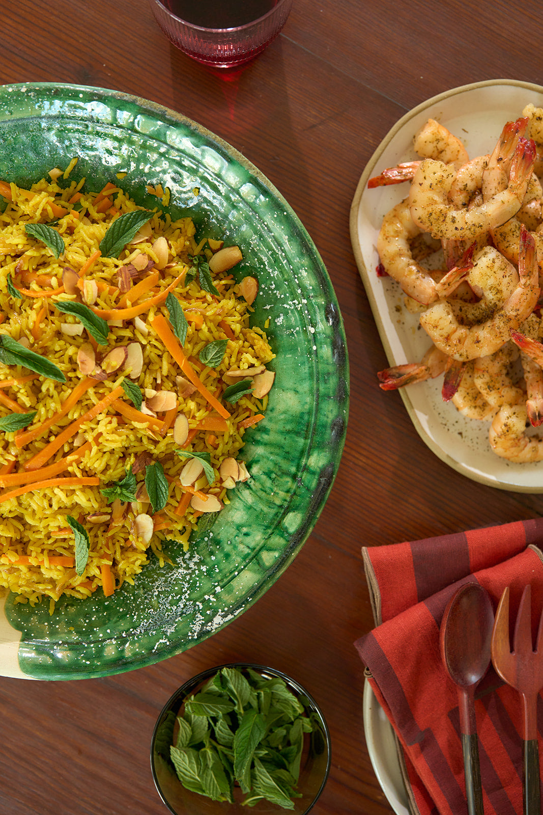 Plate with Turmeric Rice Pilaf, and Grilled Shrimp on a wooden table.
